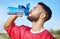 Man, soccer and hydration drinking water for sports, health and energy in fitness outdoors. Athletic football player