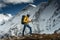 Man solo hiker exploring high altitude mountains. Tourist with mountain clothes walking across track