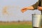 Man sows grain throwing it on the ground