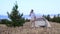 A man speaks on the phone in the woods near the tent