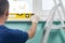 A man in special clothes checks the level of the window sill after installing a plastic window