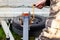 A man spins the winch handle on a car trailer. Towing and transportation of special equipment, loading and unloading of