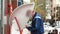 Man in sport costume Using ATM Bank Machine Outdoors. Automated teller machine