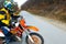 Man in sport equipment riding a motorcross bike in mountains