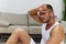 Man sports resting on the floor during a break from a workout, pumped up man fitness trainer works out at home, the