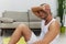 Man sports resting on the floor during a break from a workout, pumped up man fitness trainer works out at home, the