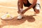 Man in sports shorts tying shoe-strings on his sneakers