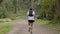 Man in sportswear running on trail in forest