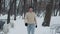 Man in sportswear walking in snow covered park