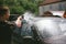 A man sprays a cleaning agent washing a high pressure on the car