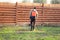 Man sprays grass with herbicide of a knapsack sprayer