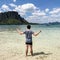 man spread his hands on beach. Man on beach hold hands arms up, rear man spread his hands on beach. Man on beach.