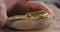 Man spread pistachio cream over ciabatta slice closeup