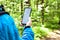 A man in the spring with a smartphone in the forest. Remote work concept. Search for the area. Communication for work