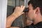 Man is spying his neighbours with binoculars