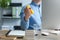 Man squeezing antistress ball while working with computer in office, closeup