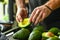 man squeezing avocados for ripeness