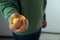 Man squeezing yellow stress ball indoors, closeup