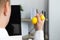 Man squeezing yellow stress ball in office, closeup