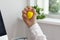 Man squeezing yellow stress ball in office, closeup