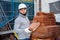 Man stacking red bricks