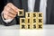 Man stacking wooden risk blocks