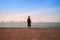 Man stand alone on the sea beach at sunset haze Calm sea