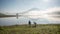 The man stand by lake anh Alone tree on the lake, sunrise at the mountai, foggy, cloud on the sky