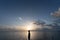 Man stand on pier inthe sea with sunrise scene above his head / thinking concept / human knowledge / design thinking / work on hol