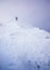Man stand pointing on snow steep ridge