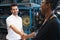 Man stand and shakehand with woman after deal succeed. Diversity of two people, caucasian business manager work with African