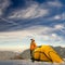 Man stand with yellow tent