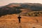 A man standing against the background of Mbeya - Chunya Roadseen from Mbeya Rift Valley view point in Mbeya Region, Tanzania