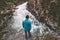 Man standing alone above river travel lifestyle