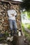 Man standing beside axe at timber shed portrait