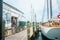 Man standing bare backed in doorway of wharf shed with walkway a