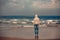 The man standing barefoot on the beach