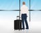 Man standing besides his luggage or suitcase at the airport window