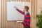 Man standing by the blackboard writes a task for class work