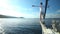 Man standing on the bow of sailing boat on Mediterranean sea.