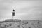 A man standing on a building which looks like a light house