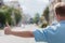 Man standing on the city street and hailing a taxi