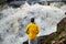 Man standing on the cliff at waterfall and thinking