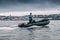 A man standing on a Cork Harbour Boat Hire boat, a company for hiring out self drive boats to general public.