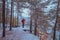 A man standing on the covered with snow rocky lakeshore