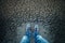 Man standing on cracked asphalt floor