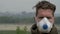 Man is standing in dense smog from forest fires in a medical mask.
