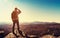 Man standing at the edge of a cliff overlooking the mountains