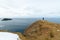 Man standing on the edge of cliffs, Shetland Islands