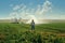 A man standing in a field with a sprinkle of water. Agriculture land